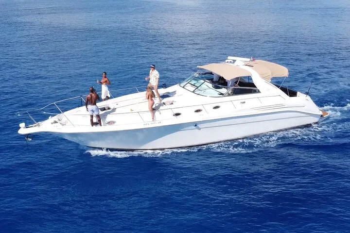 Private white motor yacht cruising deep blue Caribbean water on a private Playa del Carmen boat tour charter, Mexico